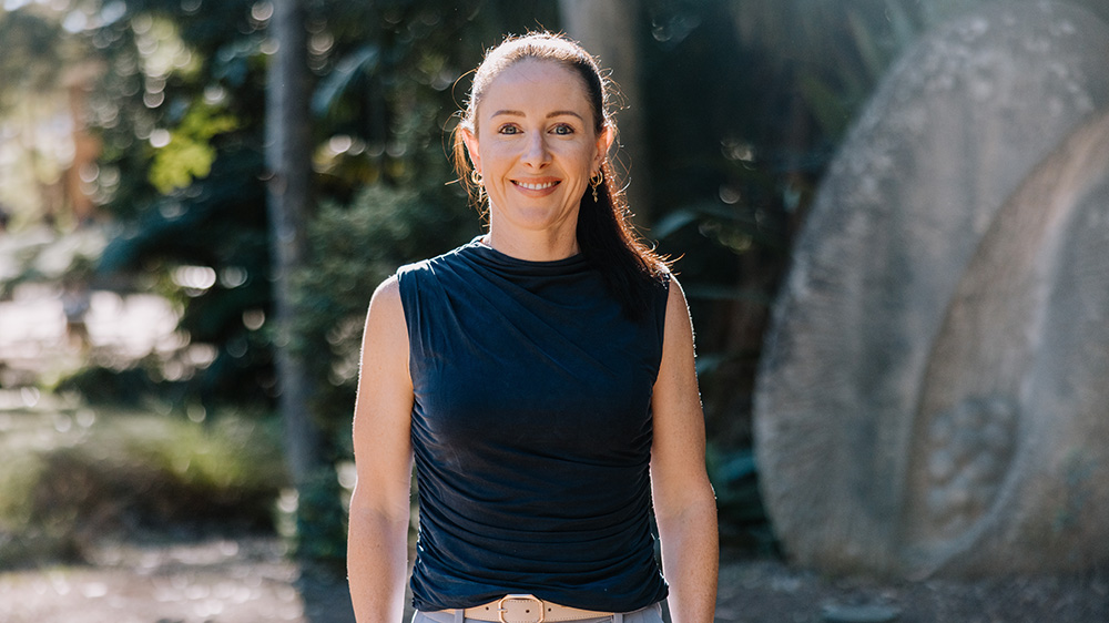 Dr Stephanie Perkiss from UOW's School of Business outdoors on the Wollongong campus on a sunny day.