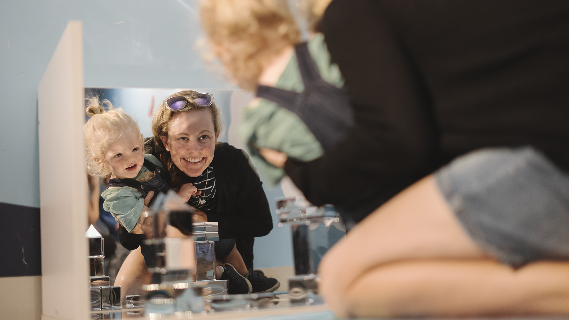 Mother and child engage with mirror play experiences at Discovery Space