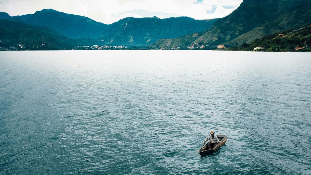 Brown canoe sails on lake