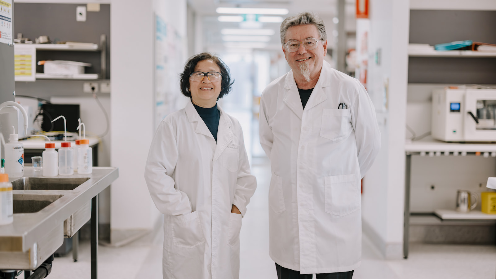 A man and a woman in white coats stand in a laboratory setting. Photo: Michael Gray