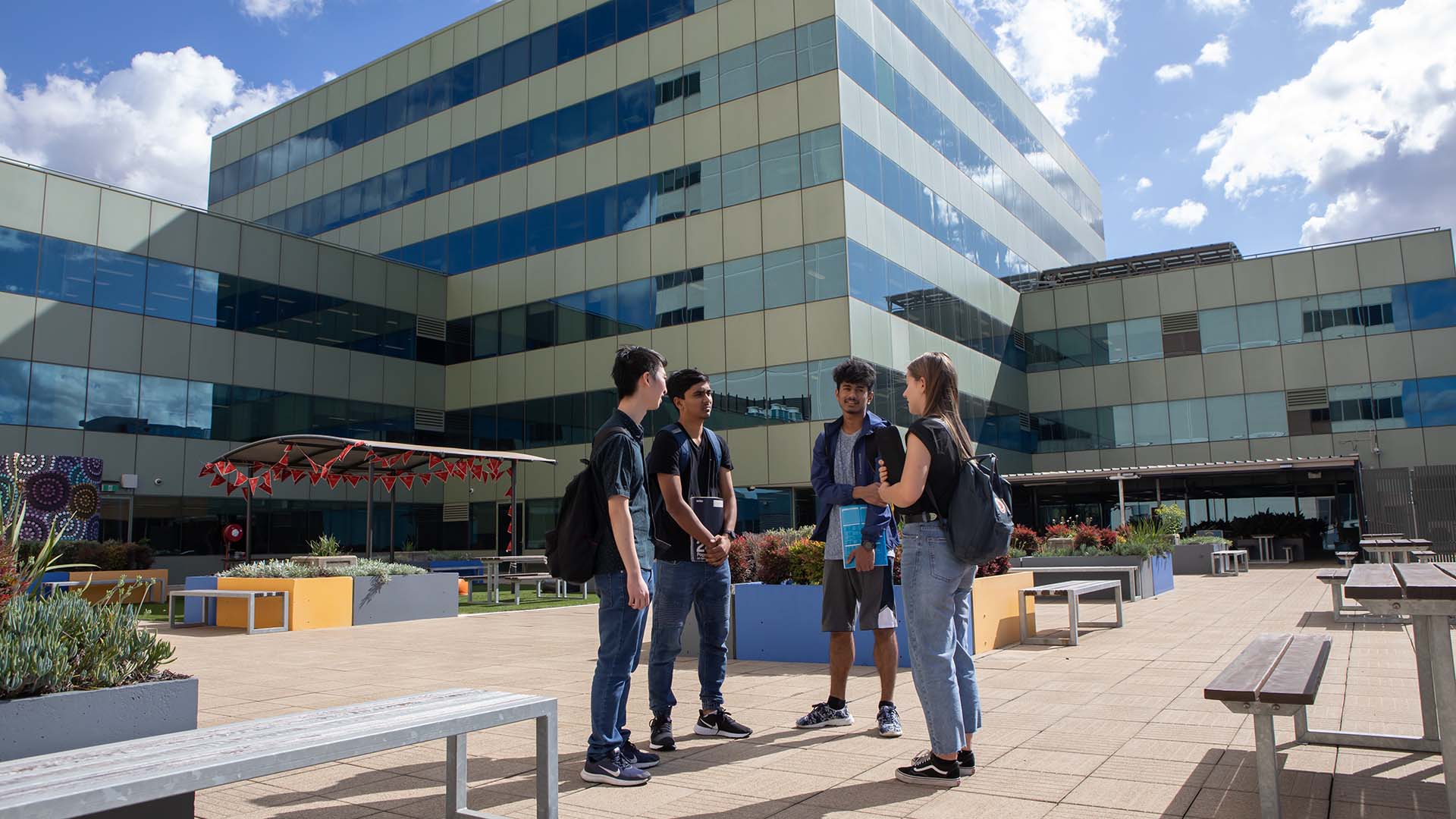 A group of students chatting outdoors at UOW