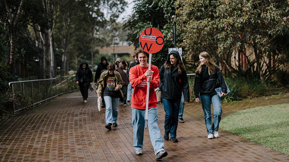 A student guide leads a group of prospective students on a tour of the Ƶapp campus at the 2024 Open Day event.