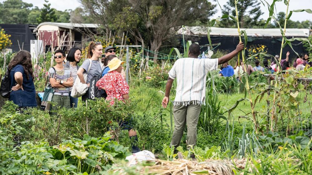 Rugare Mugumbate with a group of social work students in the garden at Dapto Community Farm. Photo: Paul Jones