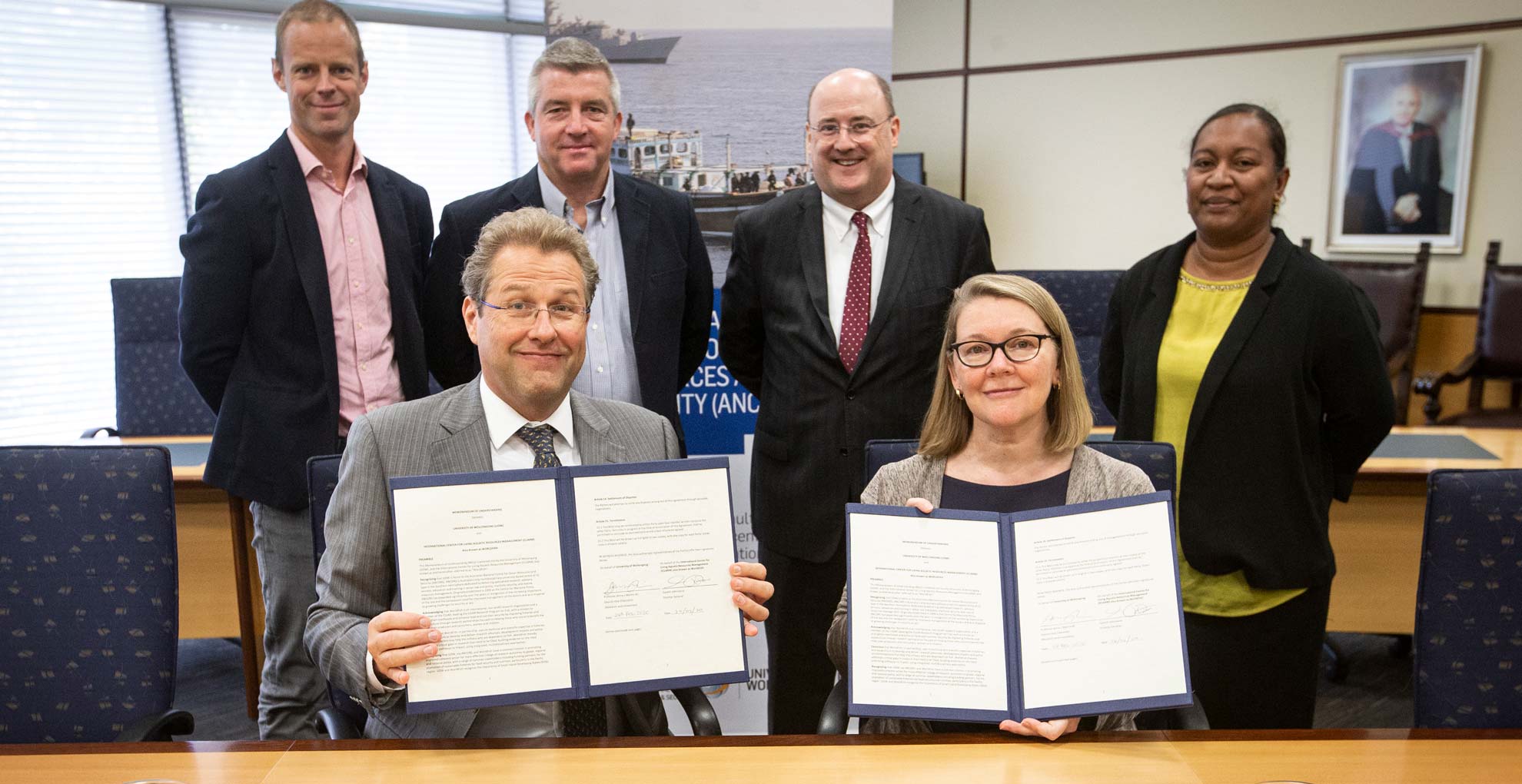 Professor Jenny Martin and Dr Gareth Johnstone (both at front) at the MOU signing between WorldFish and ANCORS at UOW. Photo: Paul Jones