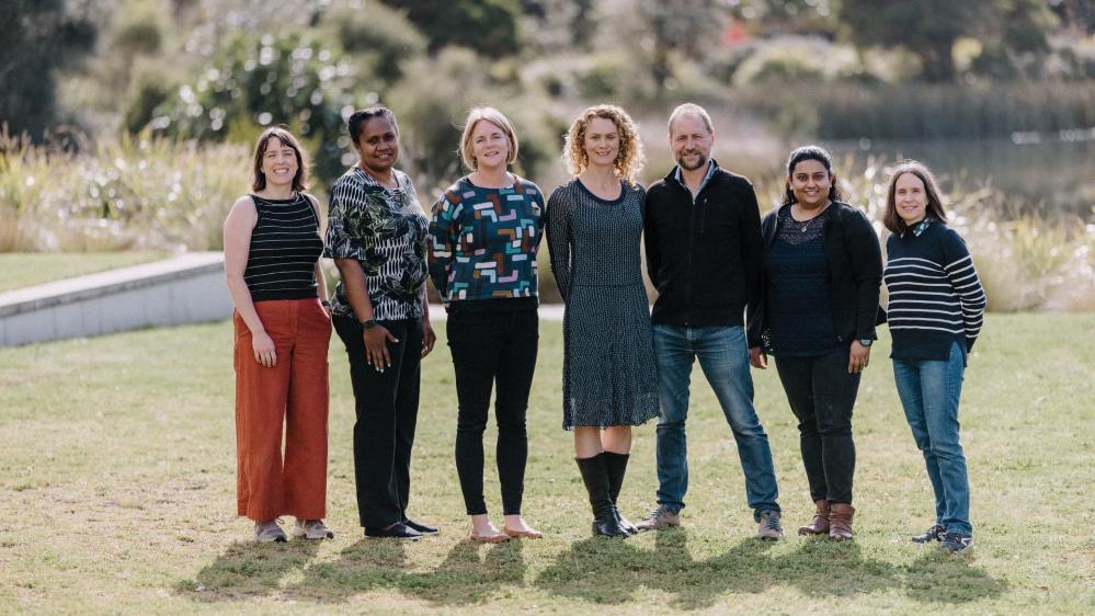 From left, ANCORS project members Elle McNeill, Tom Brewer, Anna Farmery, Lisa Wraith, Senoveva Mauli, Aurelie Delisle, Helani Kottage stand in a line in a grassy area. Photo: Michael Gray