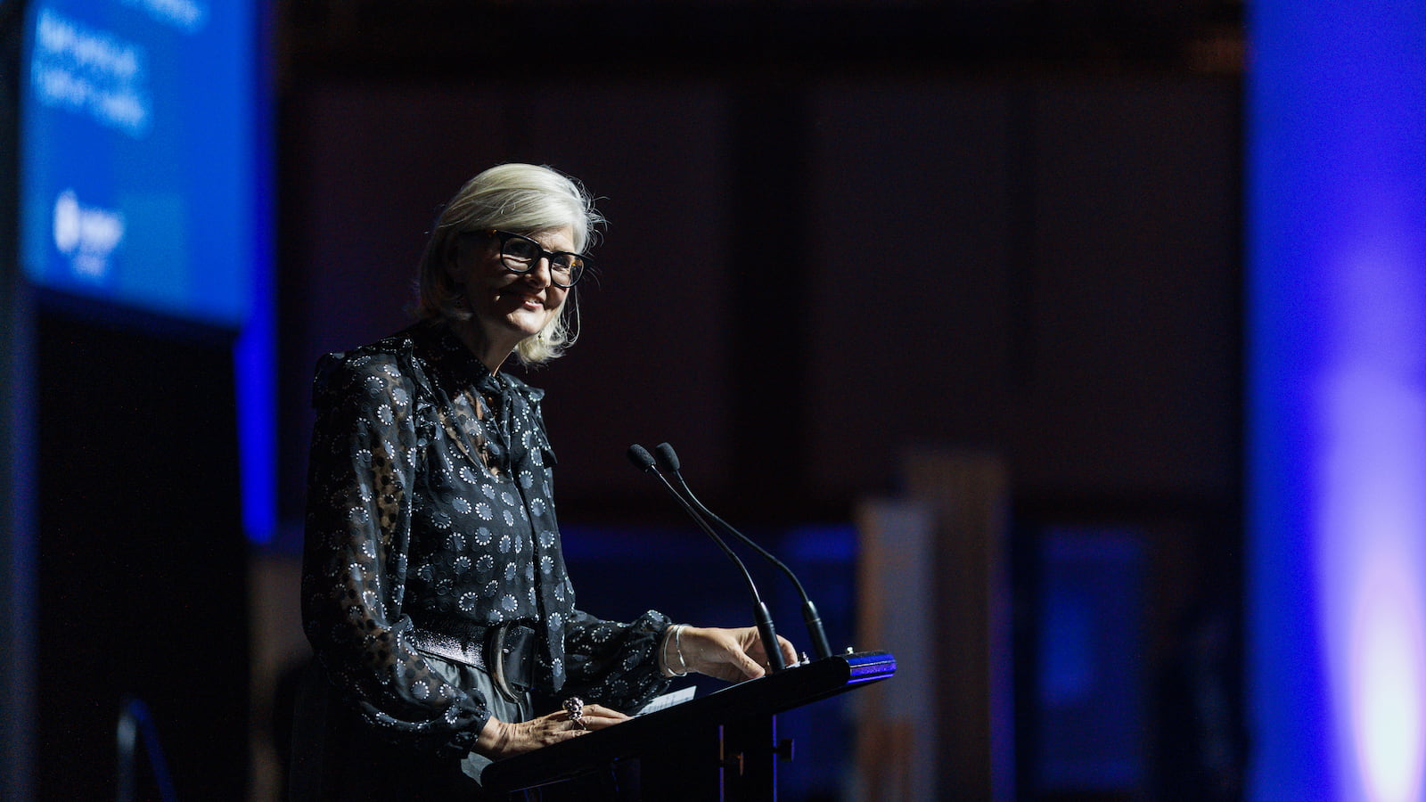 A woman stands at a lectern delivering a speech. Photo: Ben Calvert Photography