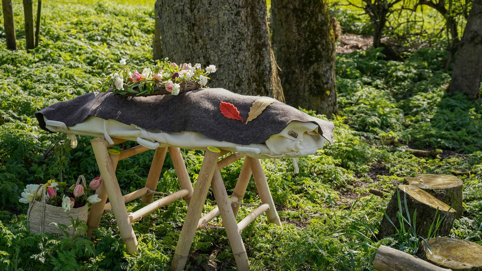 An example of an eco-friendly woodland funeral and natural burial with a woollen shroud instead of a traditional coffin (County Durham, UK). Sarah Johnson Photography. Credit: Unsplash