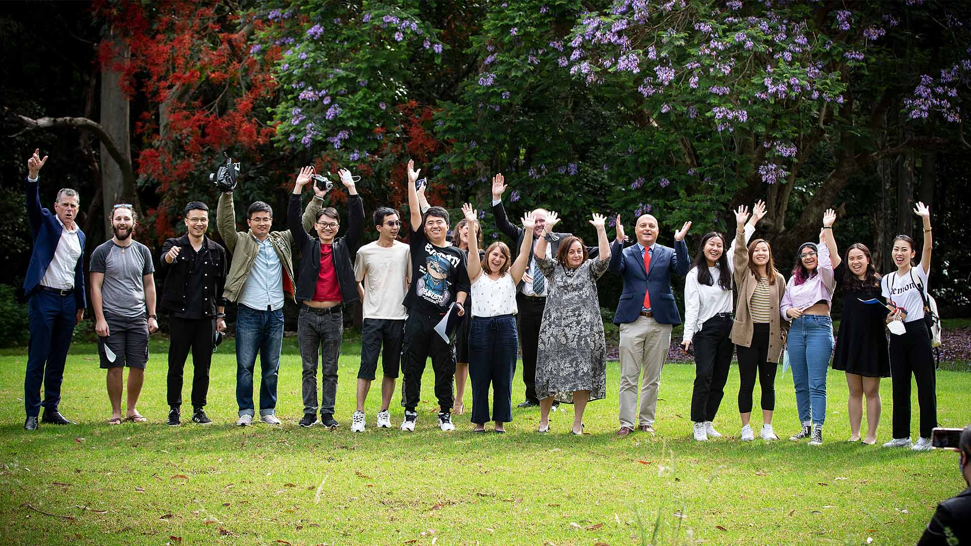 A group of students and leaders at UOW waving