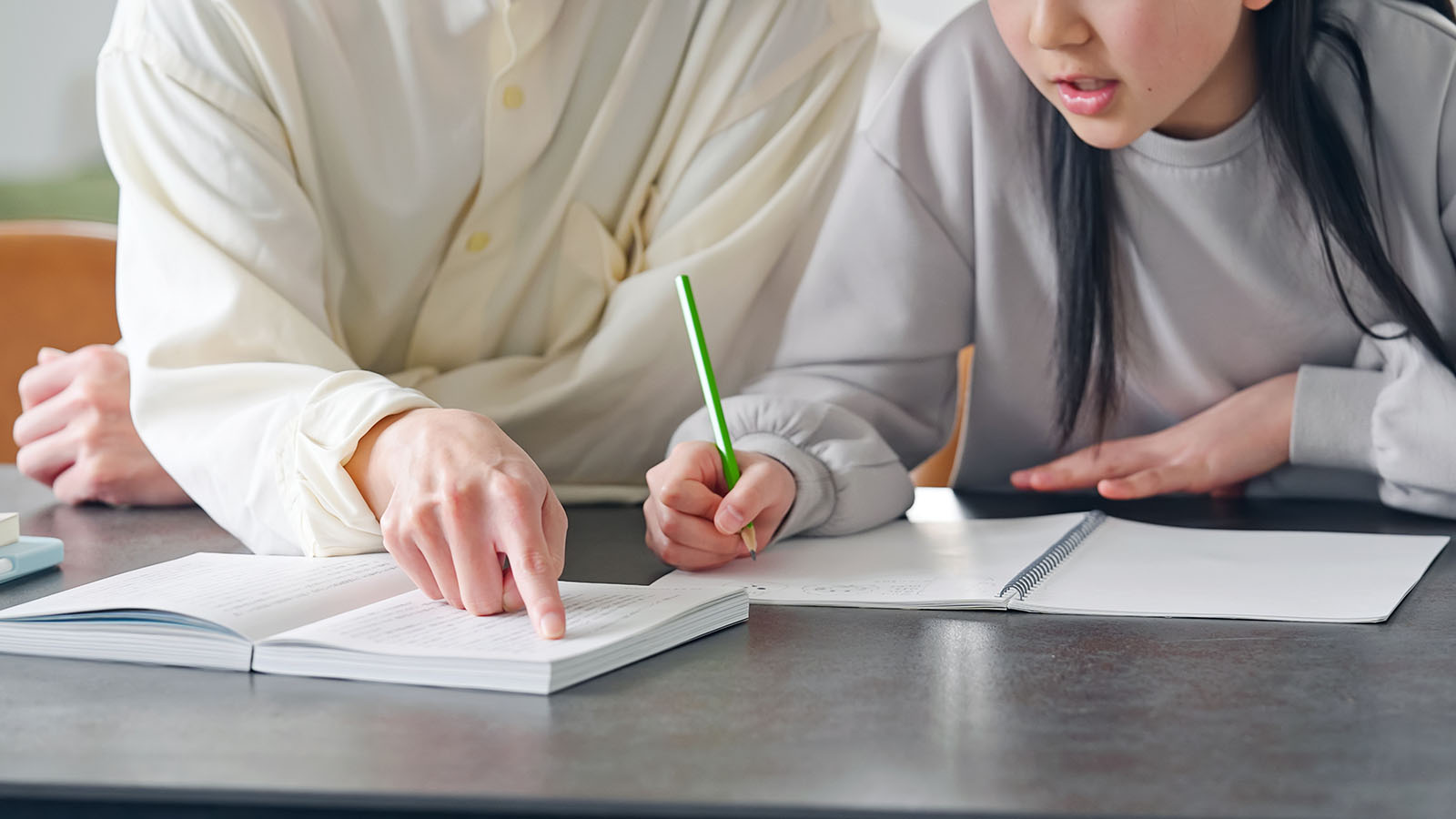 A man tutors a female high school student.
