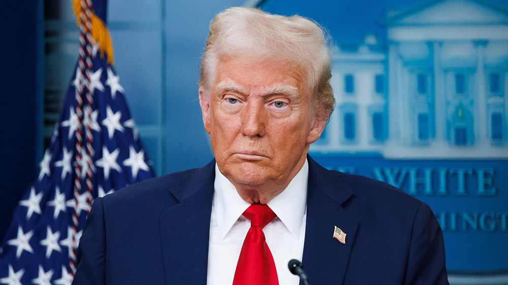 US President Donald Trump in front of an American flag.