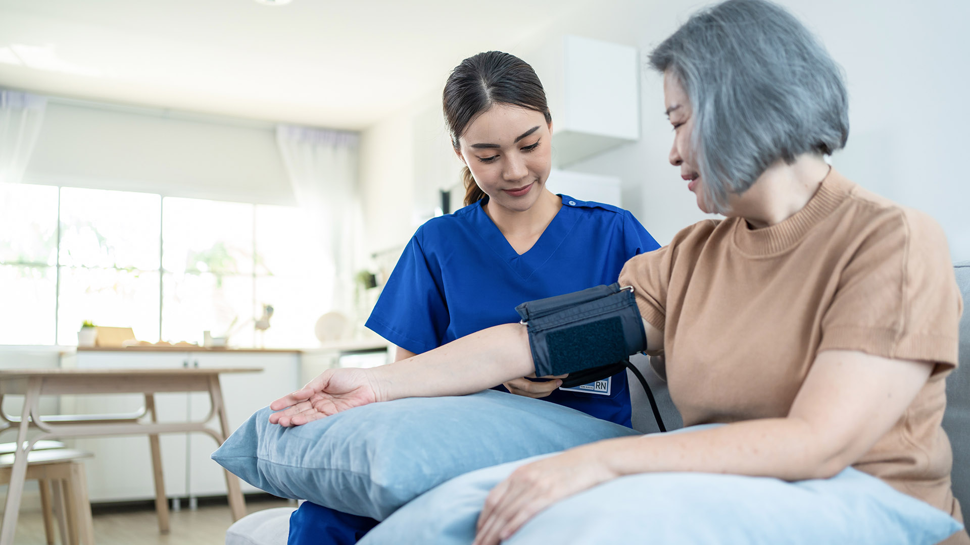 Generic image of a middle-aged women being examined by a nurse.