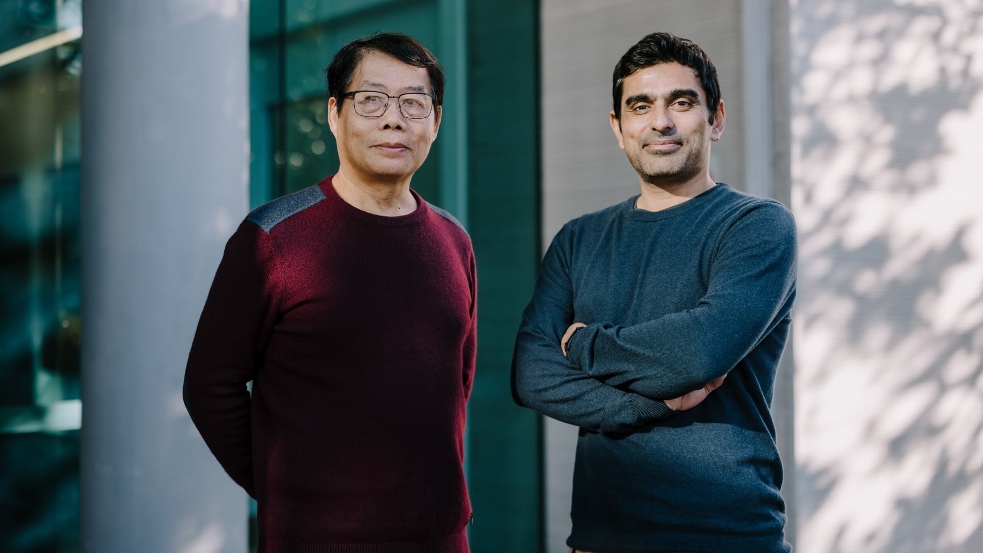 Two men stand outside a building. They are looking at the camera. Photo: Michael Gray